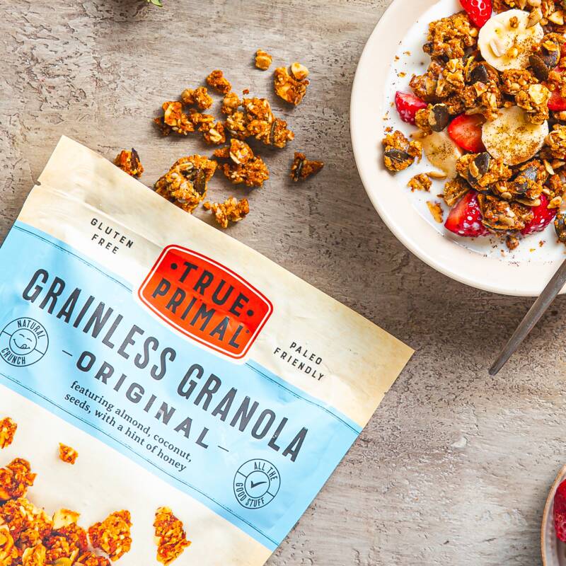 Grainless Granola Original pouch next to bowl of granola with milk and berries