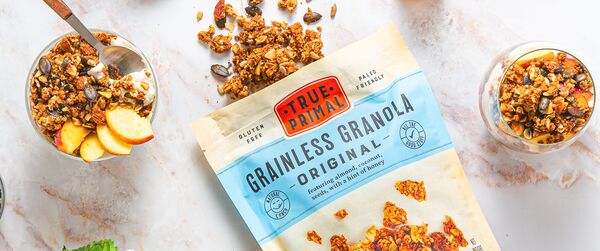 Grainless Granola Original pouch next to peach parfait