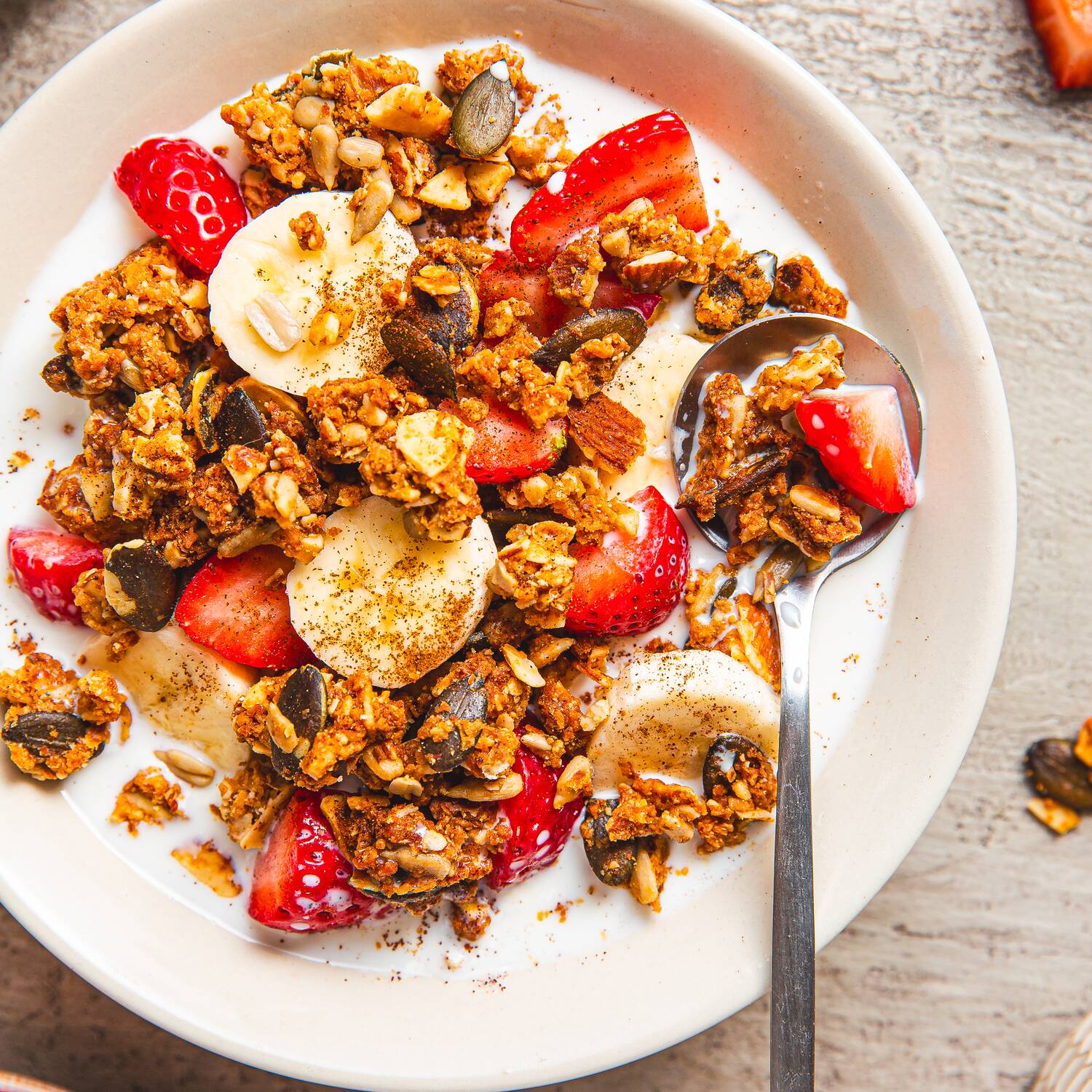 granola in bowl with milk and fresh fruit