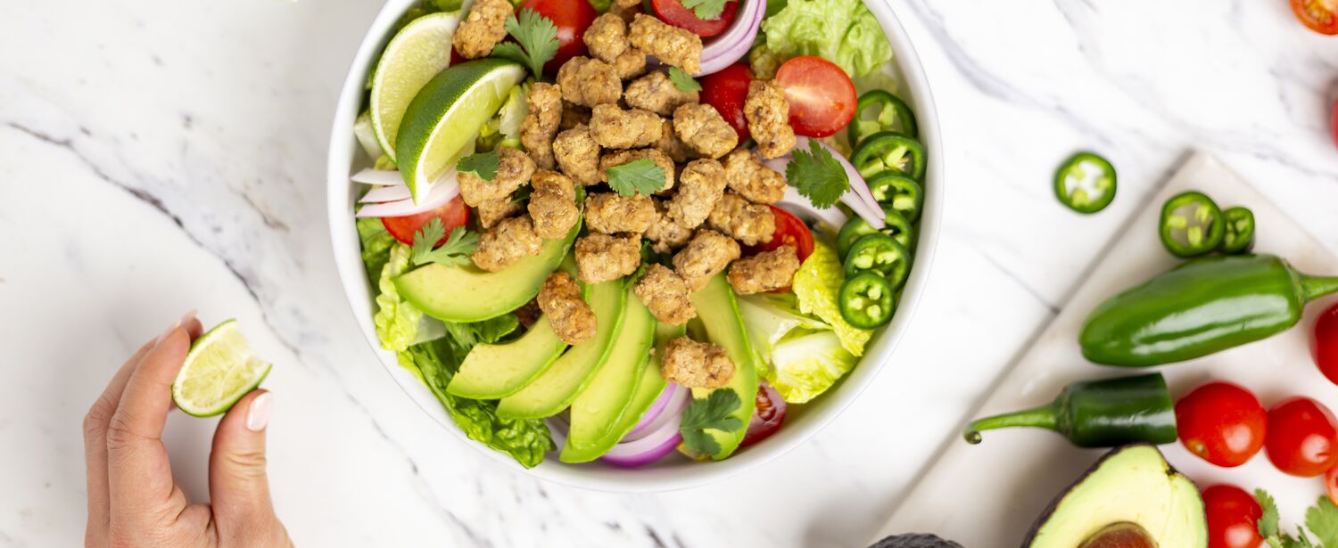 True Primal Grass-Fed Beef Mini Meatballs in bowl on salad