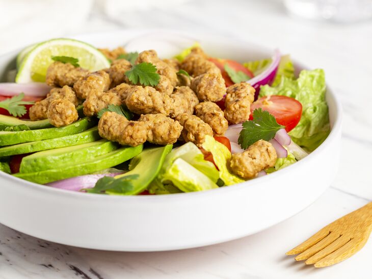 True Primal Grass-fed Beef Mini Meatballs on top of salad in a bowl