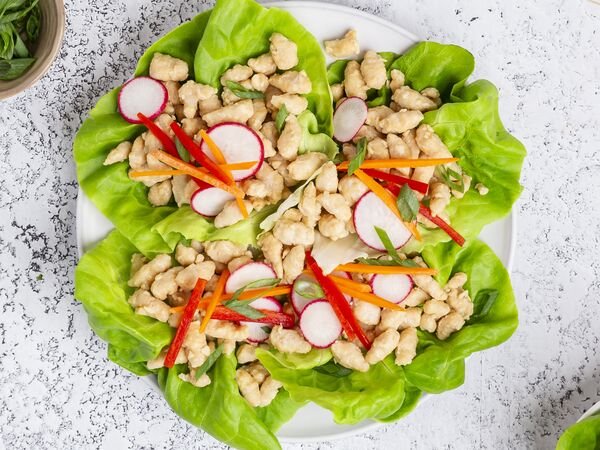 True Primal Pastured Chicken Mini Meatballs in lettuce cups on plate, viewed from above