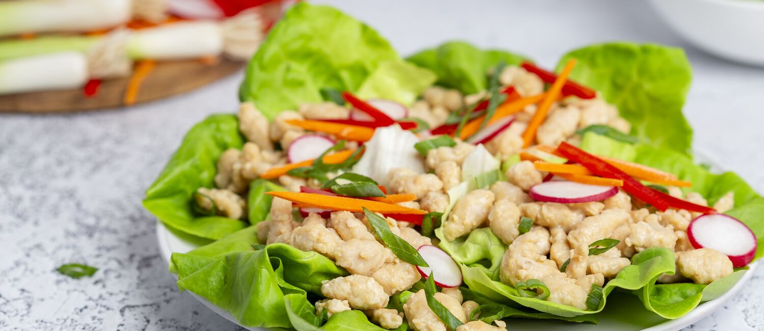 True Primal Pastured Chicken Mini Meatballs in lettuce cups on plate wide photo